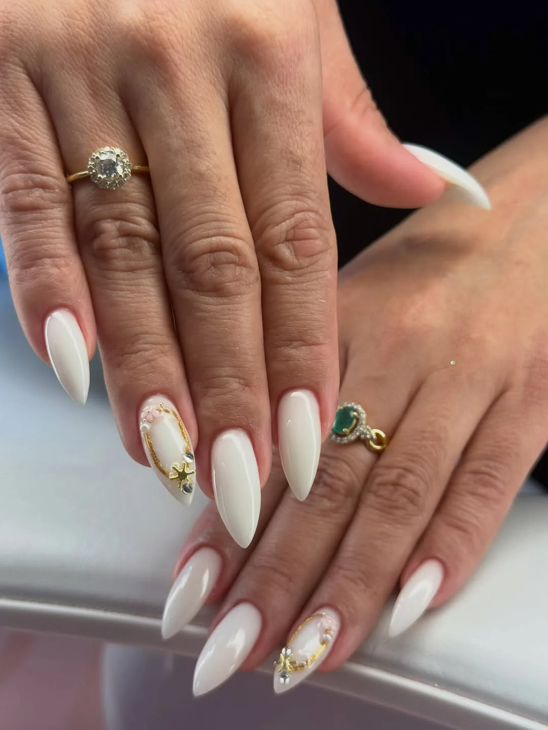Nail service in Dubai — white almond gel nails with nail art at Urban Glam
